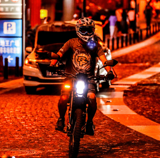 First-time rider on a Surron e dirt bike enjoying an road adventure